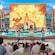 An artist rendering of the outdoor Moana, Call of the Sea stage show on the Disney Adventure, featuring performers, sea life puppets and a shallow pool